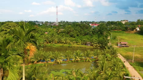 Aerial-forward-panoramic-view-of-pond-at-Medan-Johor,-Sumatra
