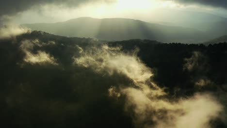 Drone-flying-above-the-mountains-with-clouds,-in-slow-motion