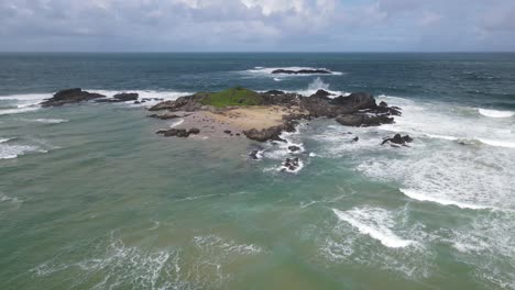 Aerial-View-Of-Island-With-Sea-Waves-Near-Sawtell-Beach-At-Daytime-In-NSW,-Australia