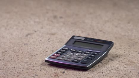 A-hammer-smashing-and-breaking-a-pocket-calculator-in-slow-motion