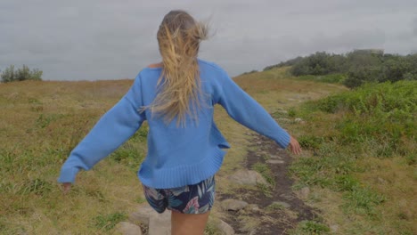 Caucasian-Woman-Walking-Towards-End-Of-Big-Nobby-Peninsula-On-A-Windy-Morning---Crescent-Head-Lookout,-NSW,-Australia