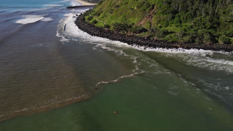 Waves-At-Rocky-Shoreline-Of-Coastal-Headland-Of-Burleigh-Heads-National-Park---Mud-Mix-At-Saltwater-Due-To-Landslide-In-Mountain---Burleigh-Heads,-QLD,-Australia