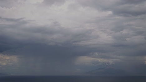 Aerial-view-of-a-rainy-day-and-clouds-on-the-sea-near-Vesuvius,-Naples-and-Capri,-Timelapse