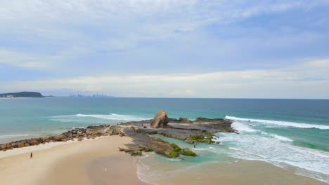 Few-People-Walking-And-Enjoying-Waves-At-Sandy-Shore-Of-Currumbin-Beach---Currumbin-Rock-At-Gold-Coast,-QLD,-Australia