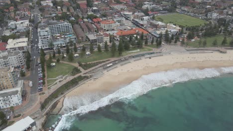 Aerial-View-Of-Coogee-Beach,-Park,-And-Oval---Coogee-Surf-Life-Saving-Club-And-Ross-Jones-Rockpool-In-Sydney,-NSW,-Australia