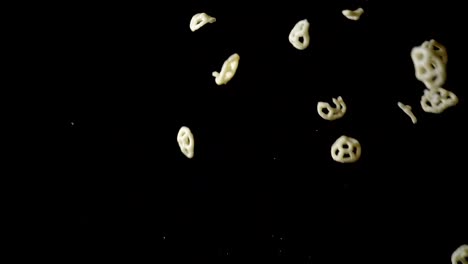 Slow-motion-of-snack-chips-flying-on-black-background