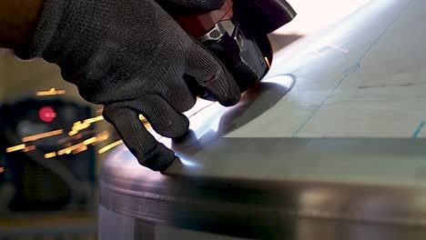 Factory-Worker-Cut-Metal-Construction-using-angle-grinder