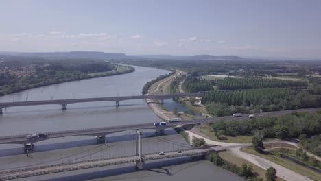 Three-transportation-bridge-crossings-over-river-Rhone-aerial-city-landscape-view-French-countryside