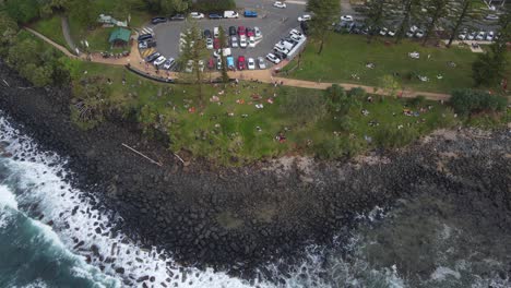 Rocky-Foreshore-Of-John-Laws-Park-With-People-On-Holiday-At-Burleigh-Heads-In-Queensland,-Gold-Coast-Australia