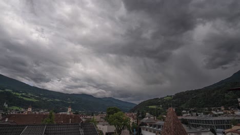 massive-cloud-front-coming-over-city-in-the-mountains,-a-storm-is-coming