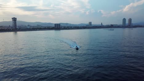 Speedboat-Drifting-Away-From-The-Coast-Of-Barcelona,-Spain-In-Full-Speed