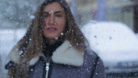 Blonde-woman-turning-around-to-face-the-camera-in-slow-motion-during-snow-fall