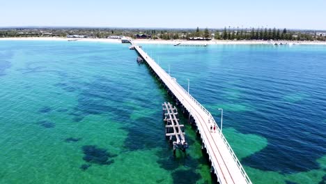 Aerial---drone-shot-of-pier-stretching-out-from-the-shore,-Western-Australia