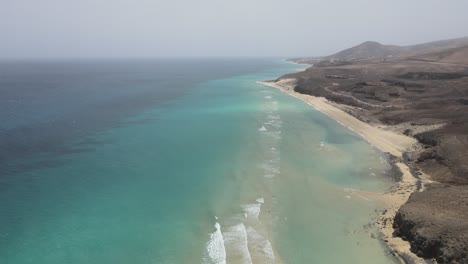 aerial-drone-shot-of-a-beautiful-beach-with-clear-water-in-Fuerteventura-in-the-Canary-Islands
