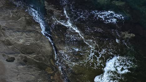 Aerial-drone-footage-of-sea-waves-hitting-the-cliff