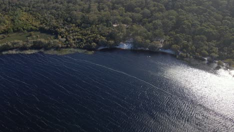 Glistening-Waters-Of-Brown-Lake-With-Shrubland---Stradbroke-Island-In-QLD,-Australia