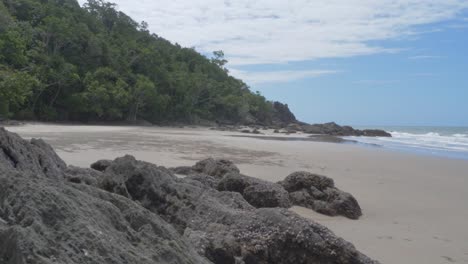 Huge-Rocks-On-Fine-Grain-White-Sand-At-Etty-Bay-Beach-In-Queensland,-Australia-With-Pacific-Ocean-Waves-Splashing
