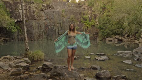 Sexy-Young-Caucasian-Woman-Wearing-Scarf-Raising-Hand-And-Looking-Up-In-The-Sky---Waterhole-At-Cedar-Creek-Falls-in-Australia