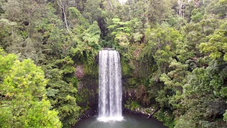 Aerial---picturesque-waterfall-and-lagoon-in-tropical-rainforest