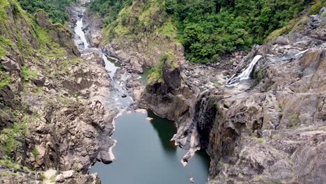 Aerial---Sweeping-views-of-waterfalls,-lakes-and-river-in-rainforest-valley