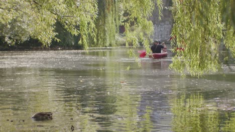 urban-city-canal-with-couple-kayak-from-behind