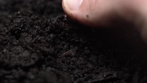 Extreme-close-up-of-a-farmer's-fingers-feeling-rich-soil,-4K