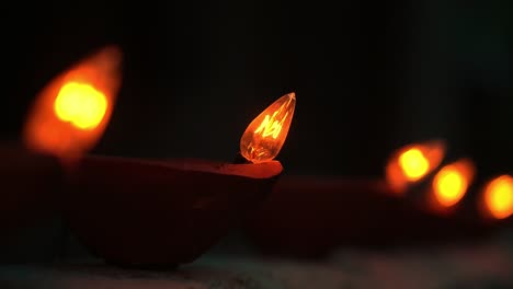 Close-up-Led-lamps,-foreground-with-OM-symbol-on-top-and-another-in-background-bokeh-defocused-blurred-at-Indian-Hindu-festival-of-lights--Diwali--decorative-item-celebration-preparation