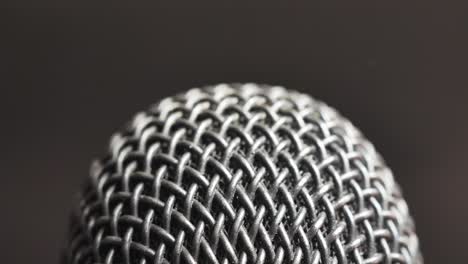 Extreme-closeup-of-old-dirty-stereo-microphone-head,-spinning