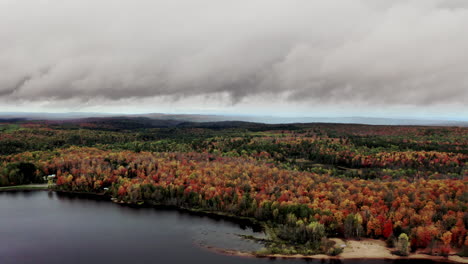 Drone-footage-of-a-stormy-Sky-over-autumn-colors