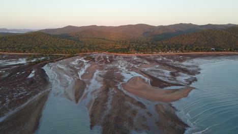 Clairview-Beach-With-Mudflat-During-Low-Tide-In-Sunset---Dense-Trees-In-Mountain-At-Isaac-Region-In-QLD,-Australia