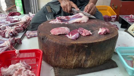Unidentified-man-cutting-and-selling-raw-goat-meat-on-his-meat-shop