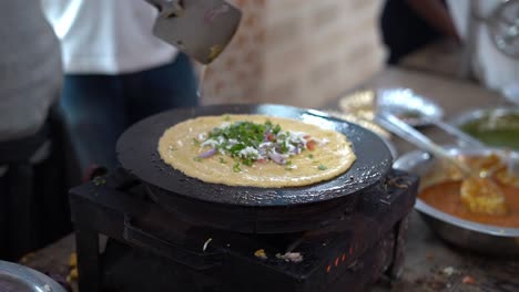 Close-up-shot-of-a-chef-making-Besan-ka-chilla-or-chickpea-flour-pancake