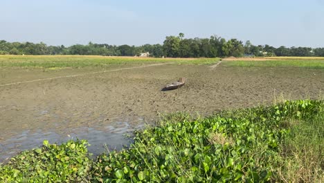 Old-vintage-wooden-boat-in-farmland-at-bortirbil,west-Bengal-after-flood