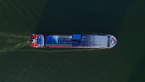 Aerial-Top-down-view-of-general-cargo-vessel-making-way-ahead-during-winter-morning