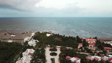 Beach-Houses-and-Idyllic-Seascape-At-Vidanta-Riviera-Maya,-Quintana-Roo,-Mexico---aerial-drone-shot