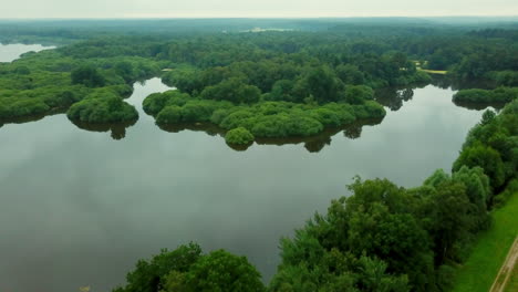 Thülsfelder-lake-near-dam-with-green-forest-moving-drone-footage-4K