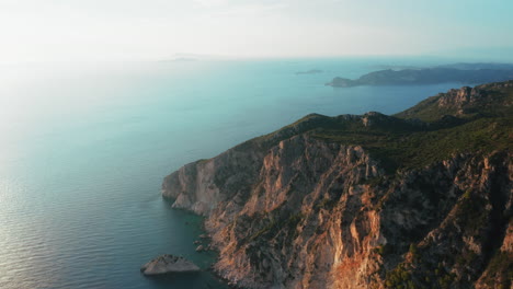 Drone-view-of-west-coast-covered-by-rocky-hills-in-Corfu-island,-Greece,-Europe