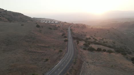 Aerial-drone-view-following-traffic-in-the-highlands-of-Golan-Heights,-sunny-evening-in-Israel