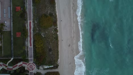 Beaches,-ocean-waves-and-green-park-filmed-from-above-in-Miami-Beach,-Florida-during-the-sunrise-hours