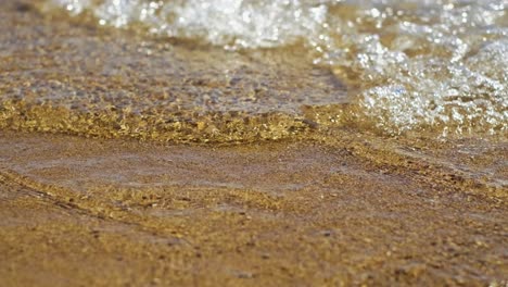 Beautiful-landscape,-a-wave-runs-on-the-sandy-shore-of-the-sea,-close-up