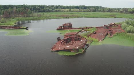 Close-up-shot-of-the-abandoned-river-freighters-of-the-Chernobyl-exclusion-zone-lying-at-the-contaminated-Pripyat-river