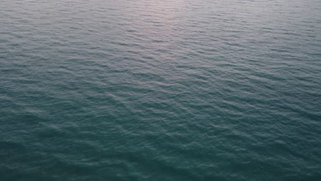 Waves-of-the-ocean-moving-slowly-in-Miami-Florida-,-filmed-from-above-by-drone