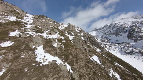 Drone-flying-over-mountain-slope-on-sunny-winter-day,-Pyrenees