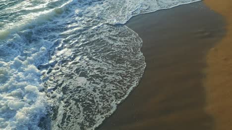 Beach,-foamy-ocean,-sea-waves-washing-sand