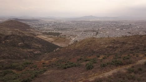 Aerial-drone-shot,-sunrise-Mexico-Pachuca-city-and-mountains