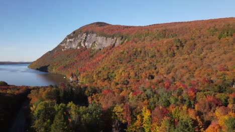 Beautiful-aerial-drone-footage-of-the-fall-leaves-on-and-around-Mount-Hor,-Mount-Pisgah,-and-Lake-Willoughby-during-peak-autumn-foliage-at-Willoughby-State-forest-in-Westmore,-Vermont