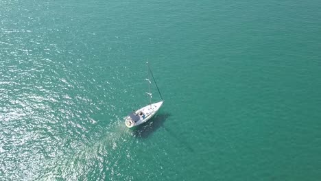 Aerial-Shot-Of-Small-Boat-Sailing-Into-Open-Blue-Ocean-Towards-His-Destination,-Cyprus