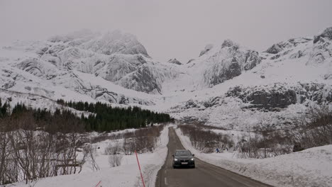 Car-on-the-road-from-Nusfjord-passing-by,-Lofoten-Islands,-Norway