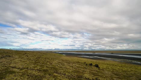 Timelapse-of-clouds-moving-over-a-river-in-a-typical-Iceland-landscape-4k