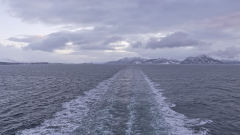 Coast-of-Senja-in-Northern-Norway-view-from-the-back-of-a-boat